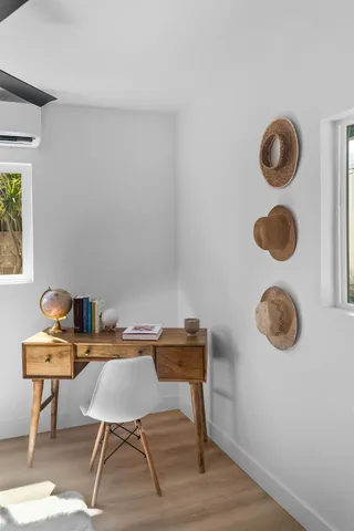 a view of a workspace with furniture and wooden floor