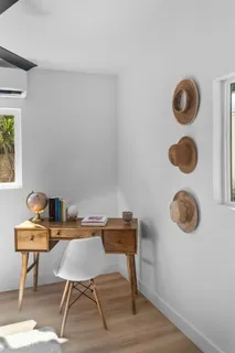 a view of a workspace with furniture and wooden floor