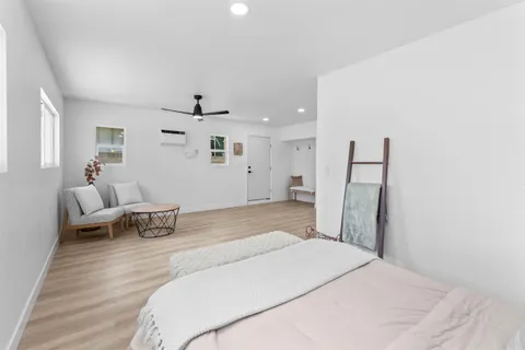 a bedroom with a bed and wooden floor