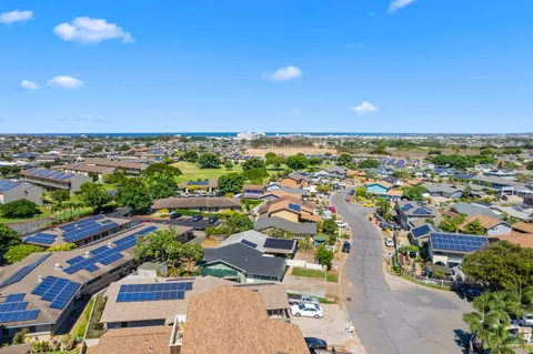 a view of a house with a yard and potted plants