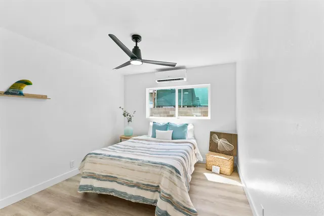 a bedroom with a bed and a large window