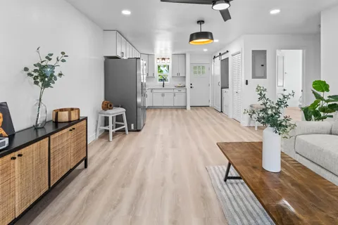 a very nice looking room with wooden floor and a potted plant