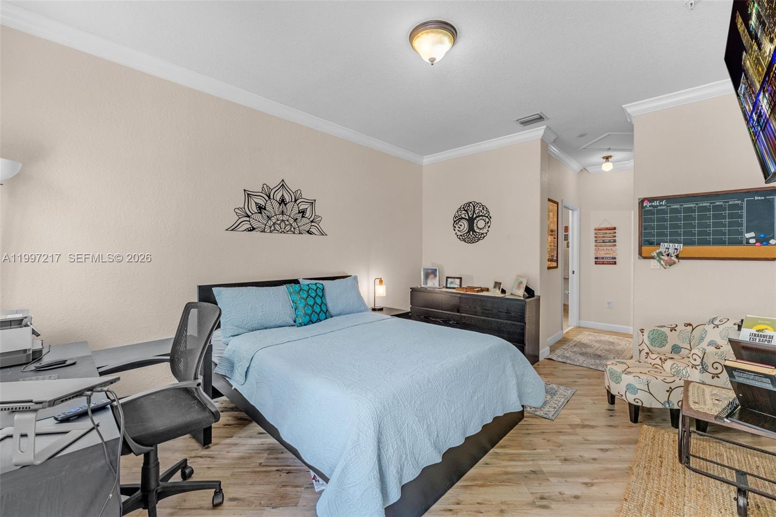 10012 Northwest 7th Street, Unit 206 Miami, FL 33172 - Photo 14 of 35 a bedroom with a bed and wooden floor