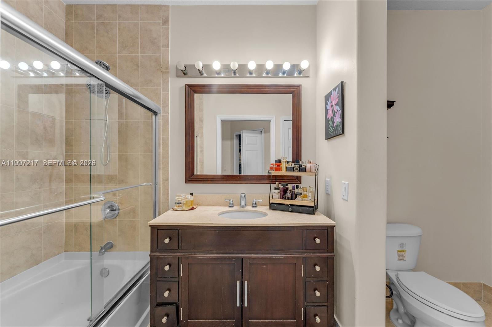 10012 Northwest 7th Street, Unit 206 Miami, FL 33172 - Photo 15 of 35 a bathroom with a sink a toilet and shower