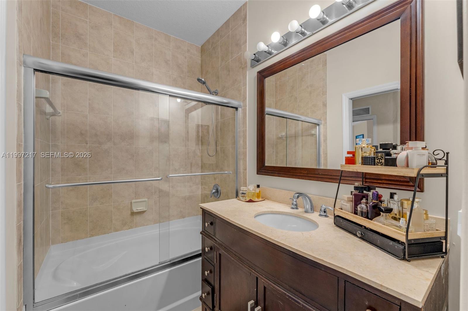 10012 Northwest 7th Street, Unit 206 Miami, FL 33172 - Photo 16 of 35 a bathroom with a sink and a mirror