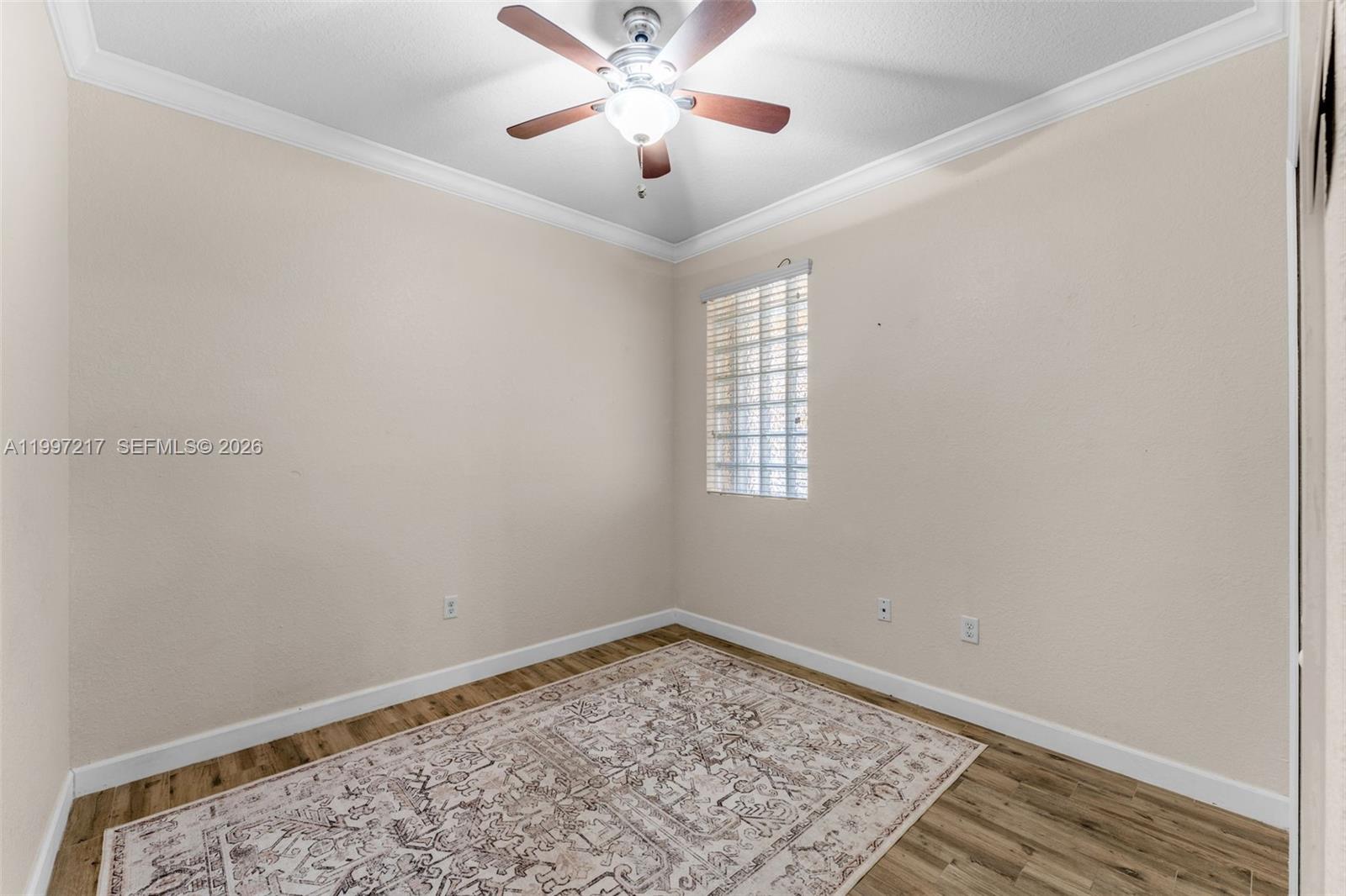 10012 Northwest 7th Street, Unit 206 Miami, FL 33172 - Photo 19 of 35 an empty room with a window and ceiling fan