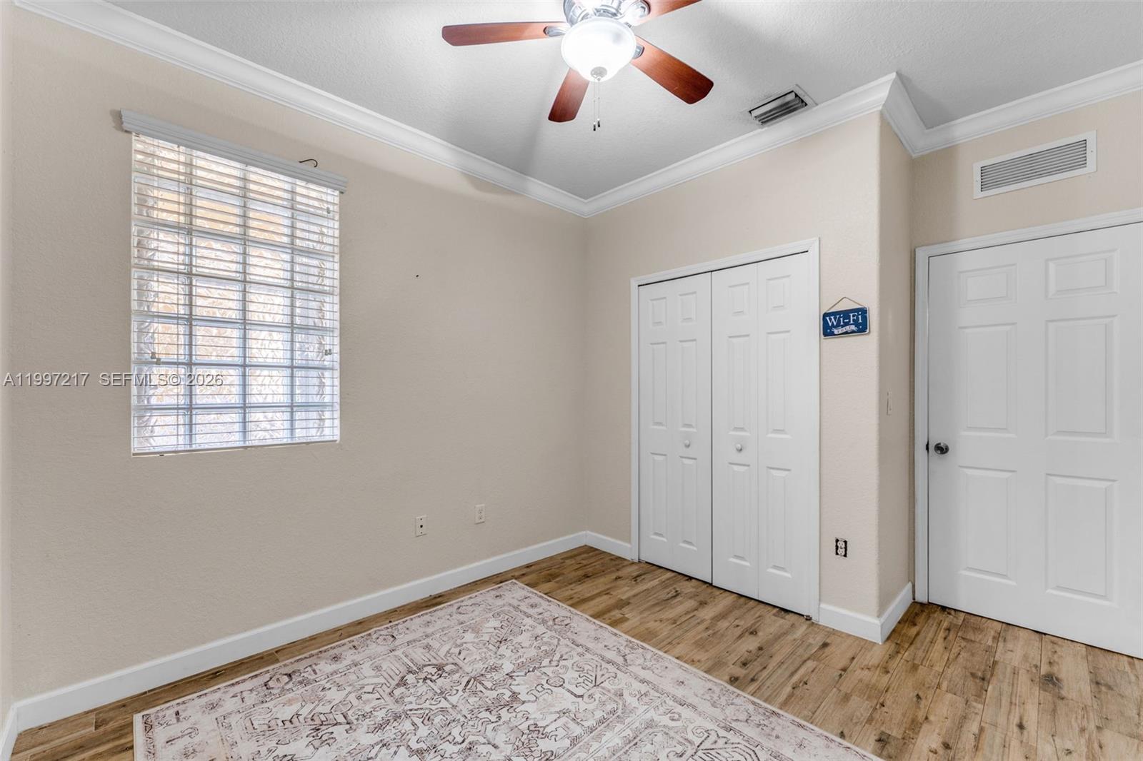 10012 Northwest 7th Street, Unit 206 Miami, FL 33172 - Photo 20 of 35 a view of an empty room with wooden floor and a window