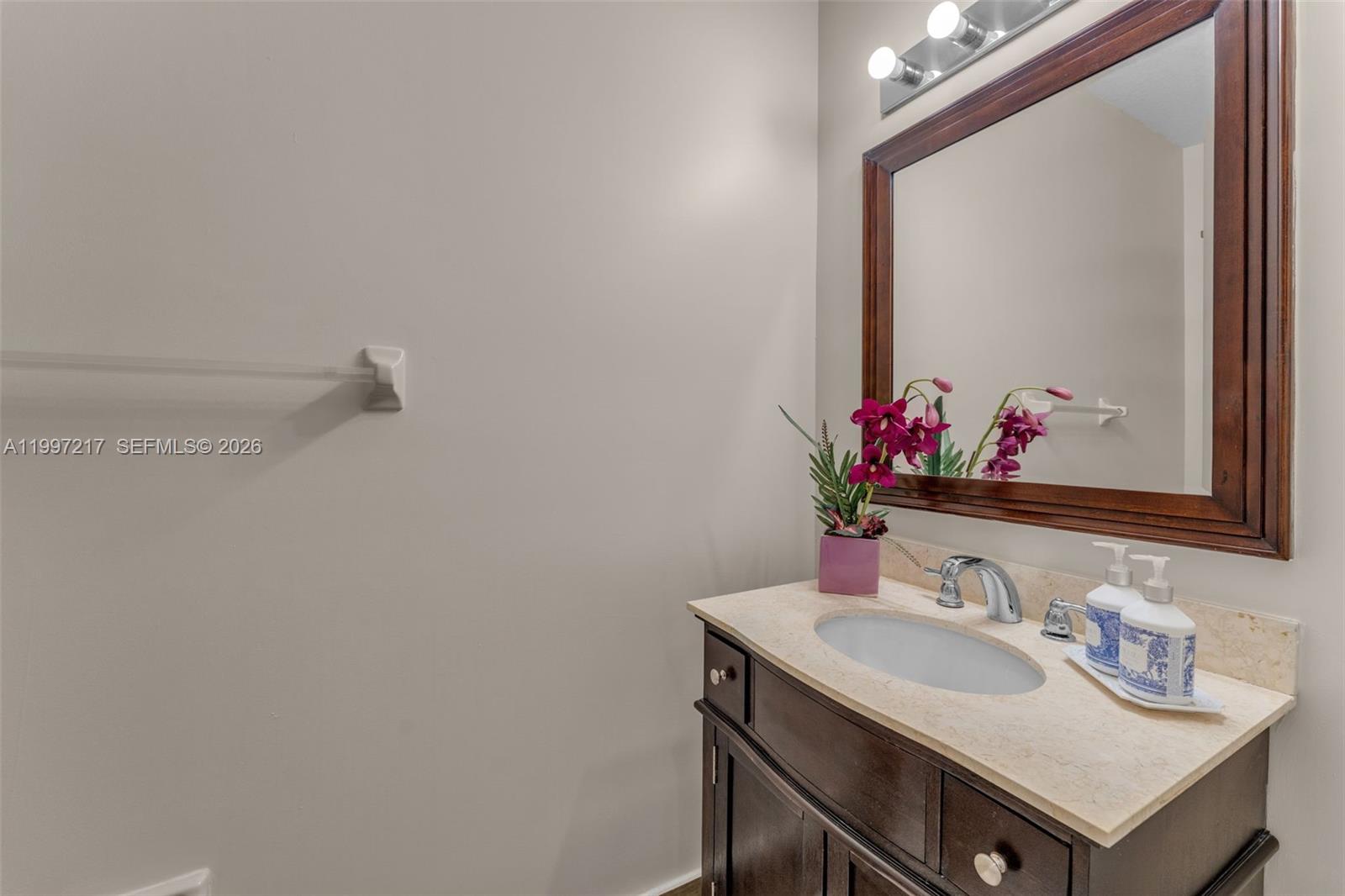 10012 Northwest 7th Street, Unit 206 Miami, FL 33172 - Photo 22 of 35 a bathroom with a sink and a mirror