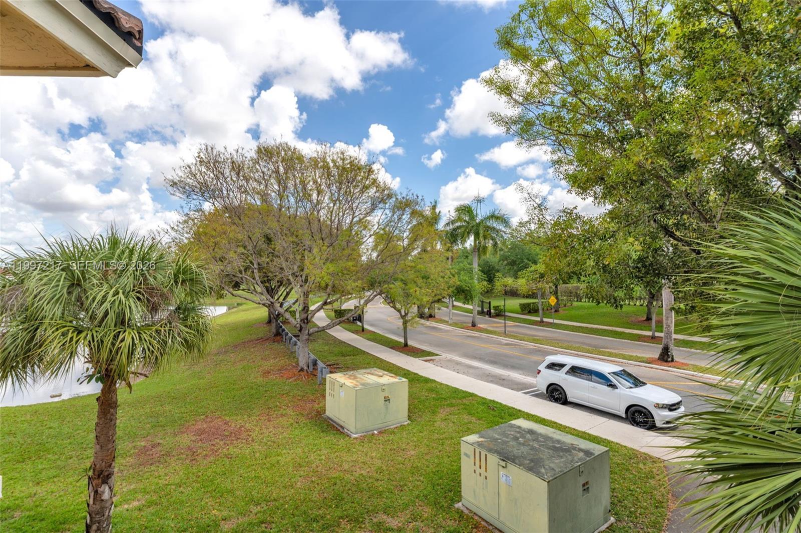 10012 Northwest 7th Street, Unit 206 Miami, FL 33172 - Photo 25 of 35 a view of a yard with table and chairs