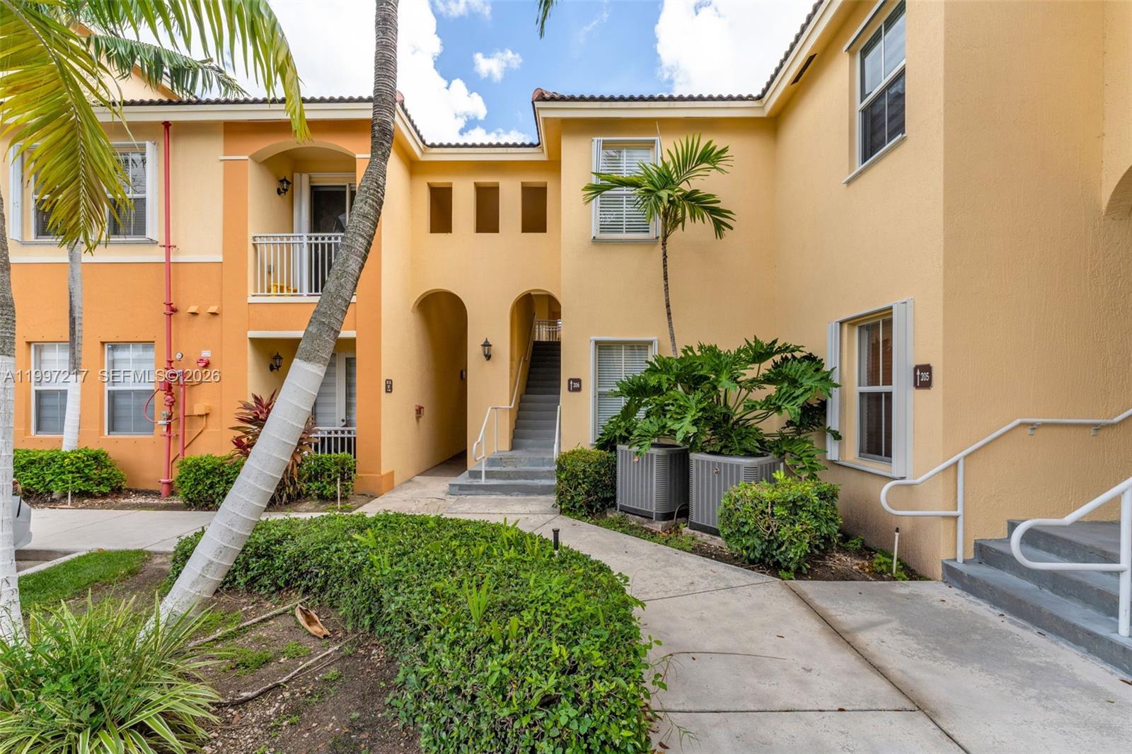 10012 Northwest 7th Street, Unit 206 Miami, FL 33172 - Photo 6 of 35 a front view of a house with a yard