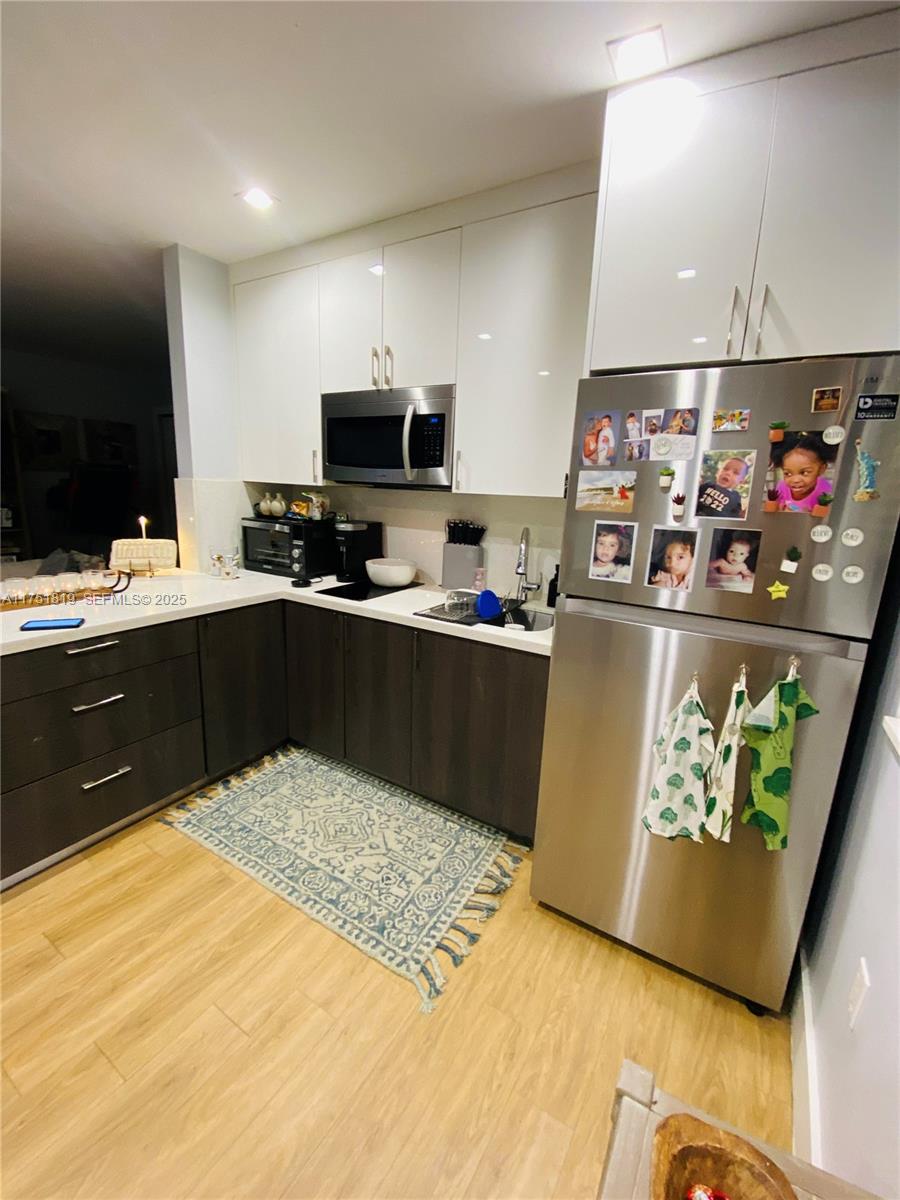 200 Azure Way Miami Springs, FL 33166 - Photo 33 of 54 a kitchen with stainless steel appliances granite countertop a sink dishwasher a stove and a refrigerator