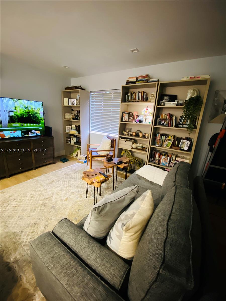 200 Azure Way Miami Springs, FL 33166 - Photo 35 of 54 a living room with furniture and a flat screen tv