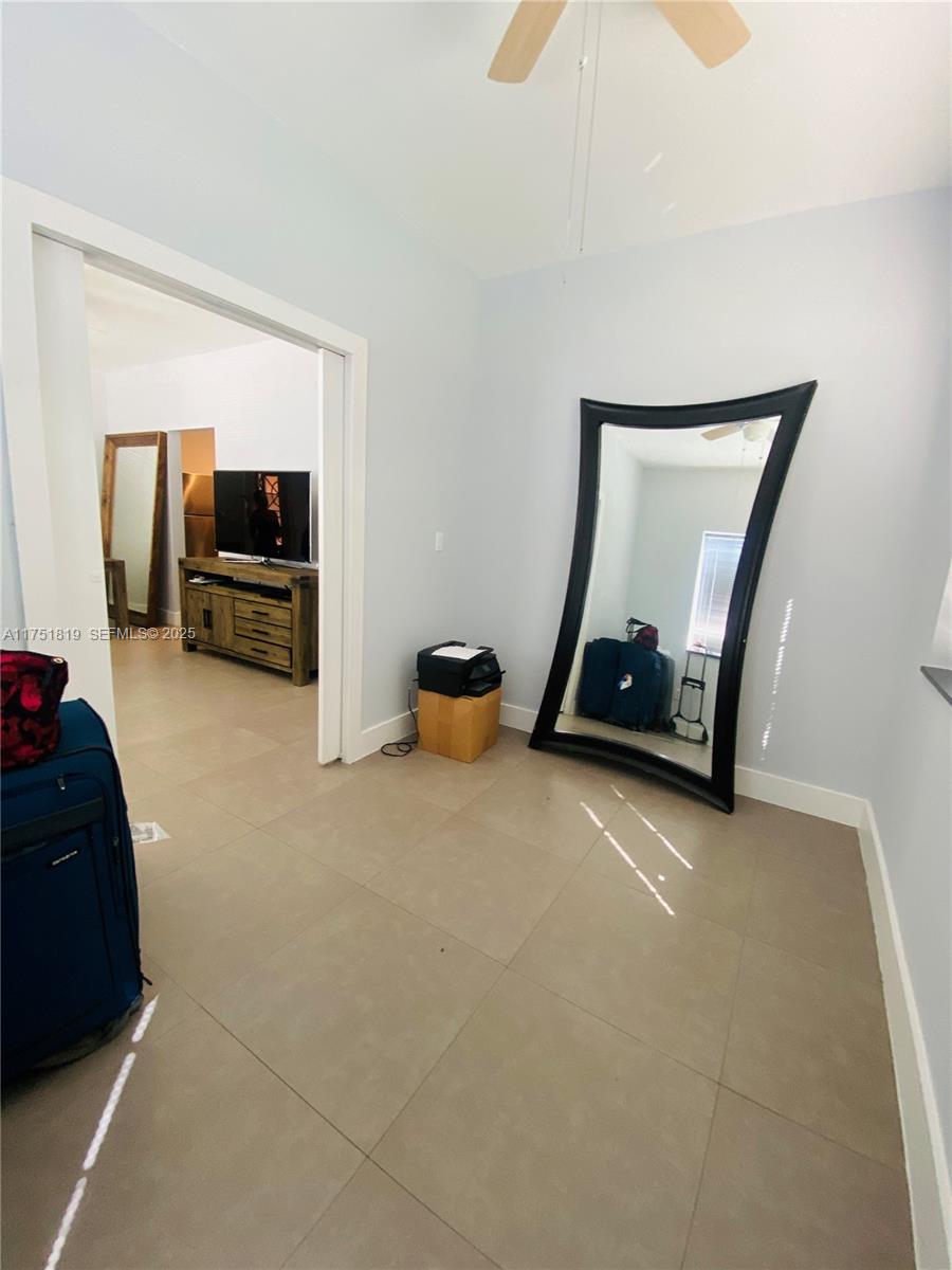 200 Azure Way Miami Springs, FL 33166 - Photo 49 of 54 a living room with furniture gym equipment and a fireplace