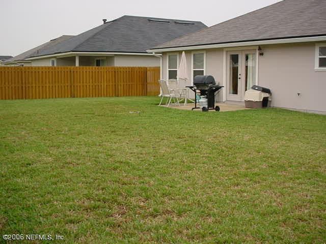 3547 Whisper Creek Boulevard Middleburg, FL 32068 - Photo 10 of 10 a front view of a house with a garden and porch