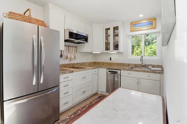 a kitchen with cabinets appliances and a counter top space