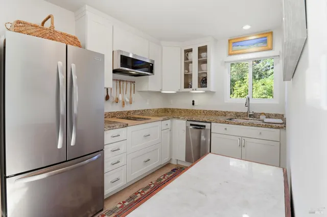 a kitchen with cabinets appliances and a counter top space