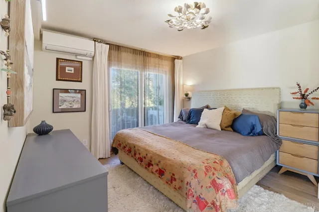 a bedroom with a bed and a painting on the wall