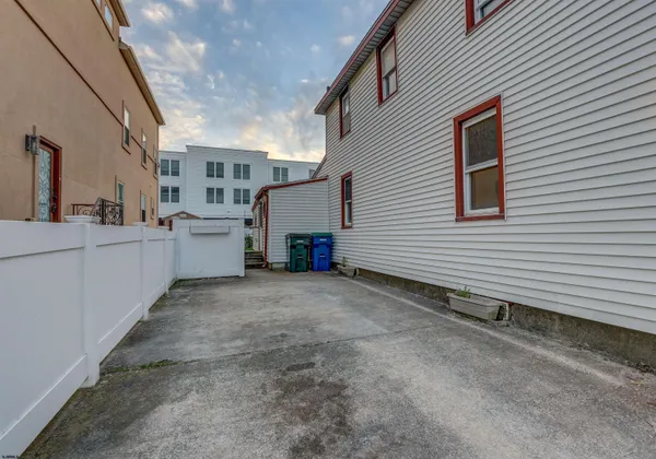 a view of a house with a backyard and garage