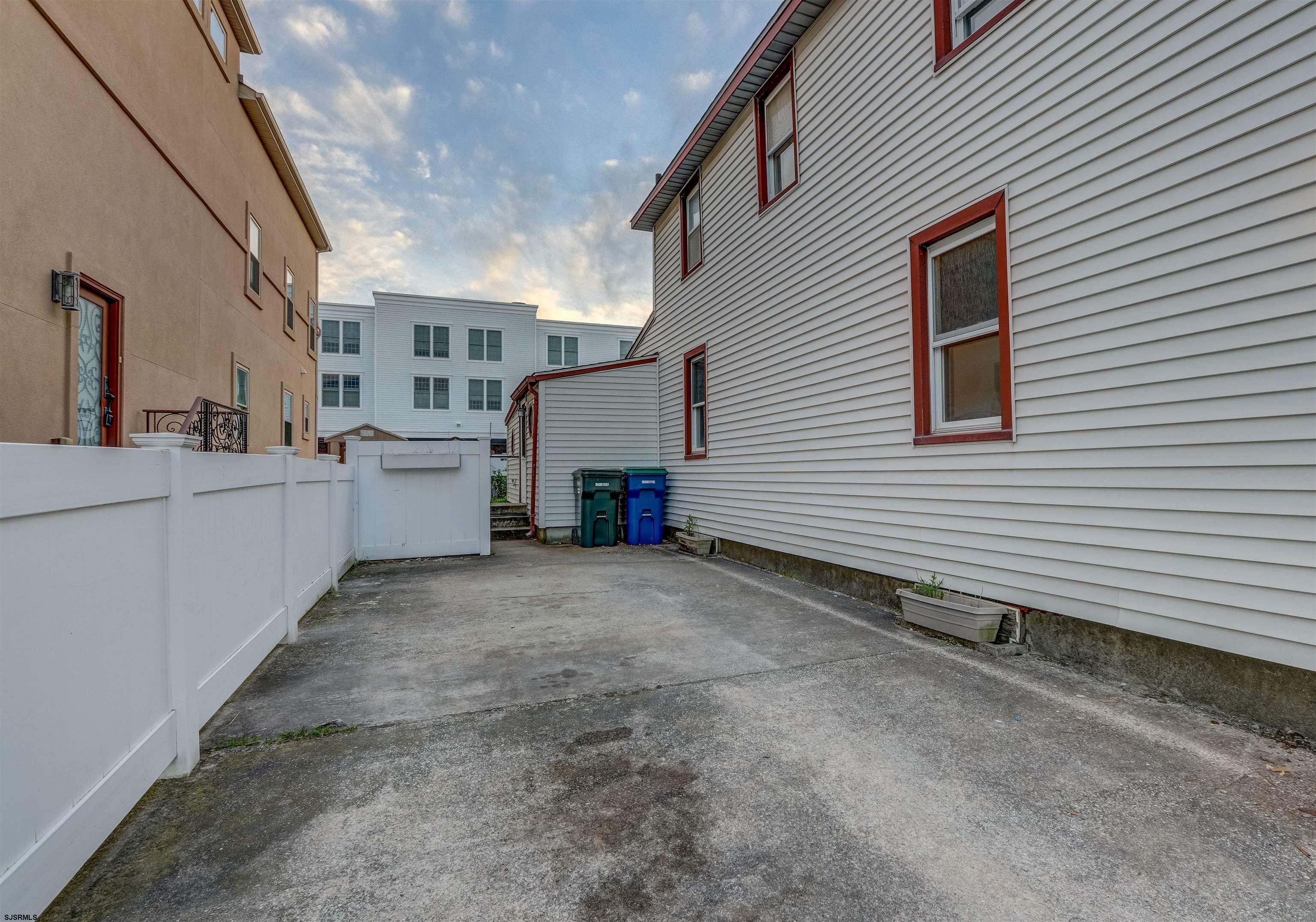 a view of a house with a backyard and garage