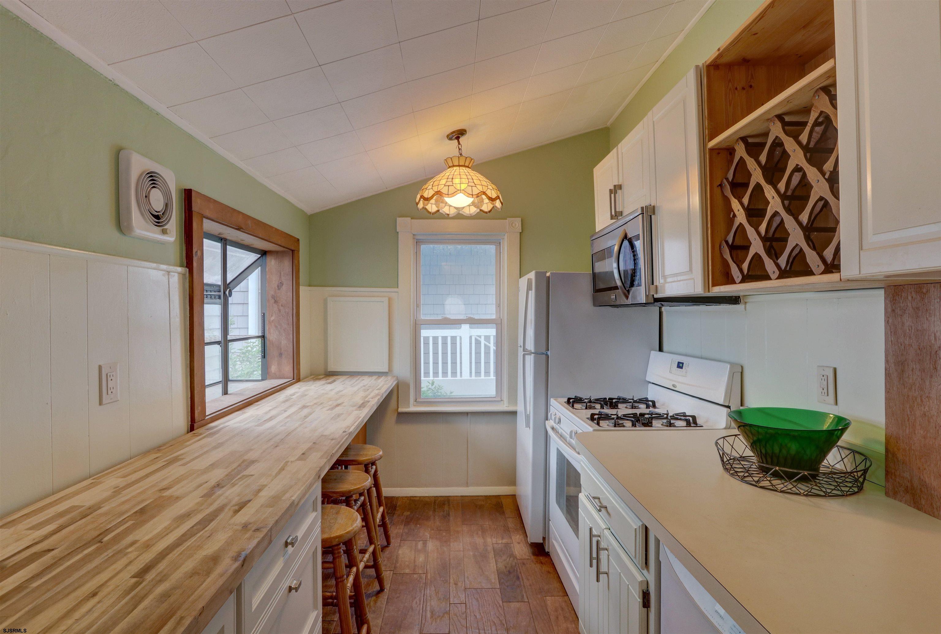 22 South Decatur Avenue, Unit 1ST HALF '26 Margate City, NJ 08402 - Photo 13 of 28 a kitchen with a table and chairs