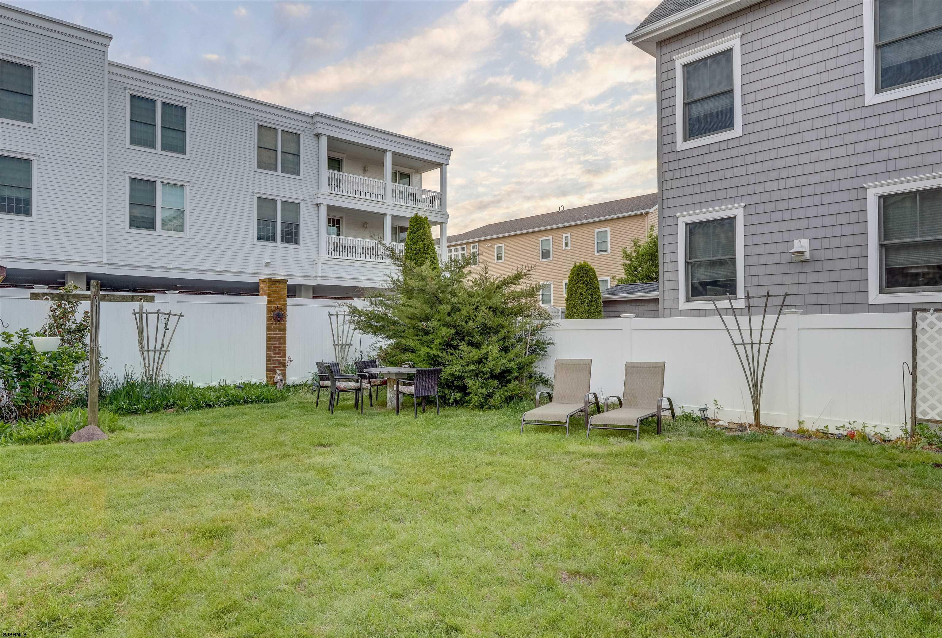 22 South Decatur Avenue, Unit 1ST HALF '26 Margate City, NJ 08402 - Photo 25 of 28 a view of a house with a yard and sitting area