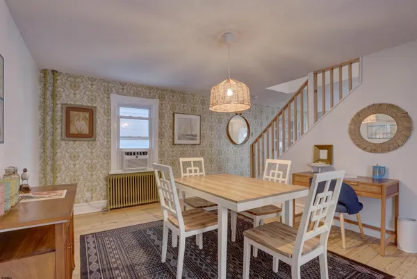 a view of a dining room with furniture and a clock