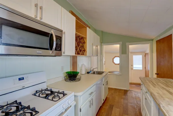 a kitchen with a sink a stove and cabinets