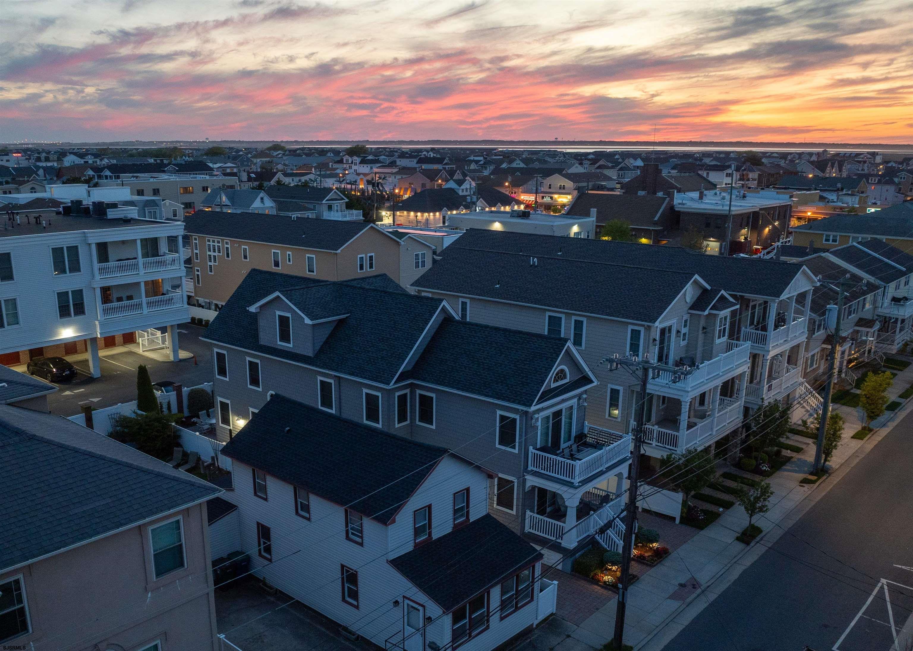 22 South Decatur Avenue, Unit 1ST HALF '26 Margate City, NJ 08402 - Photo 10 of 28 a view of a building with a mountain in the background