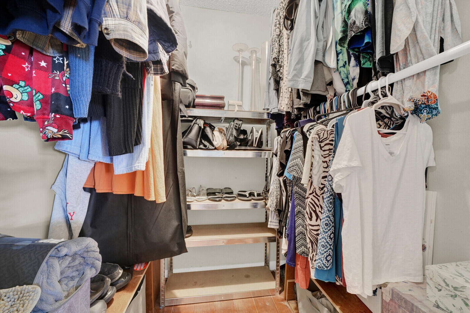10406 Sleepy Brook Way Boca Raton, FL 33428 - Photo 26 of 36 a view of walk in closet with clothes and shoes