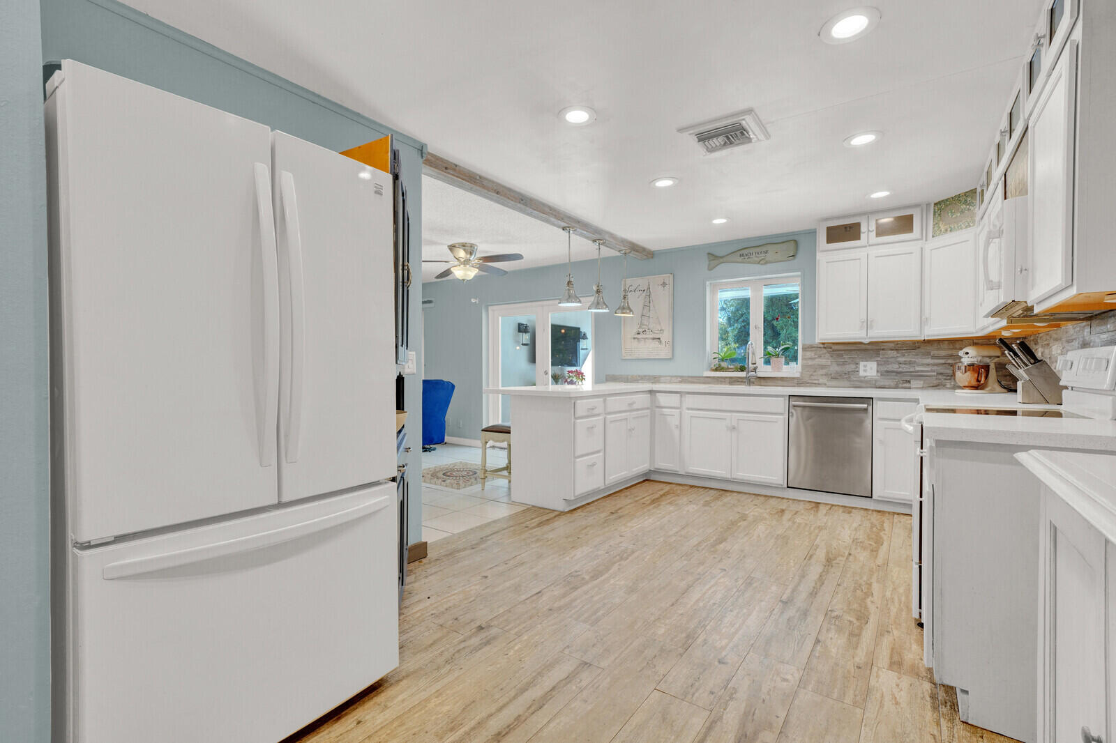 10406 Sleepy Brook Way Boca Raton, FL 33428 - Photo 7 of 36 a kitchen with white cabinets and white appliances