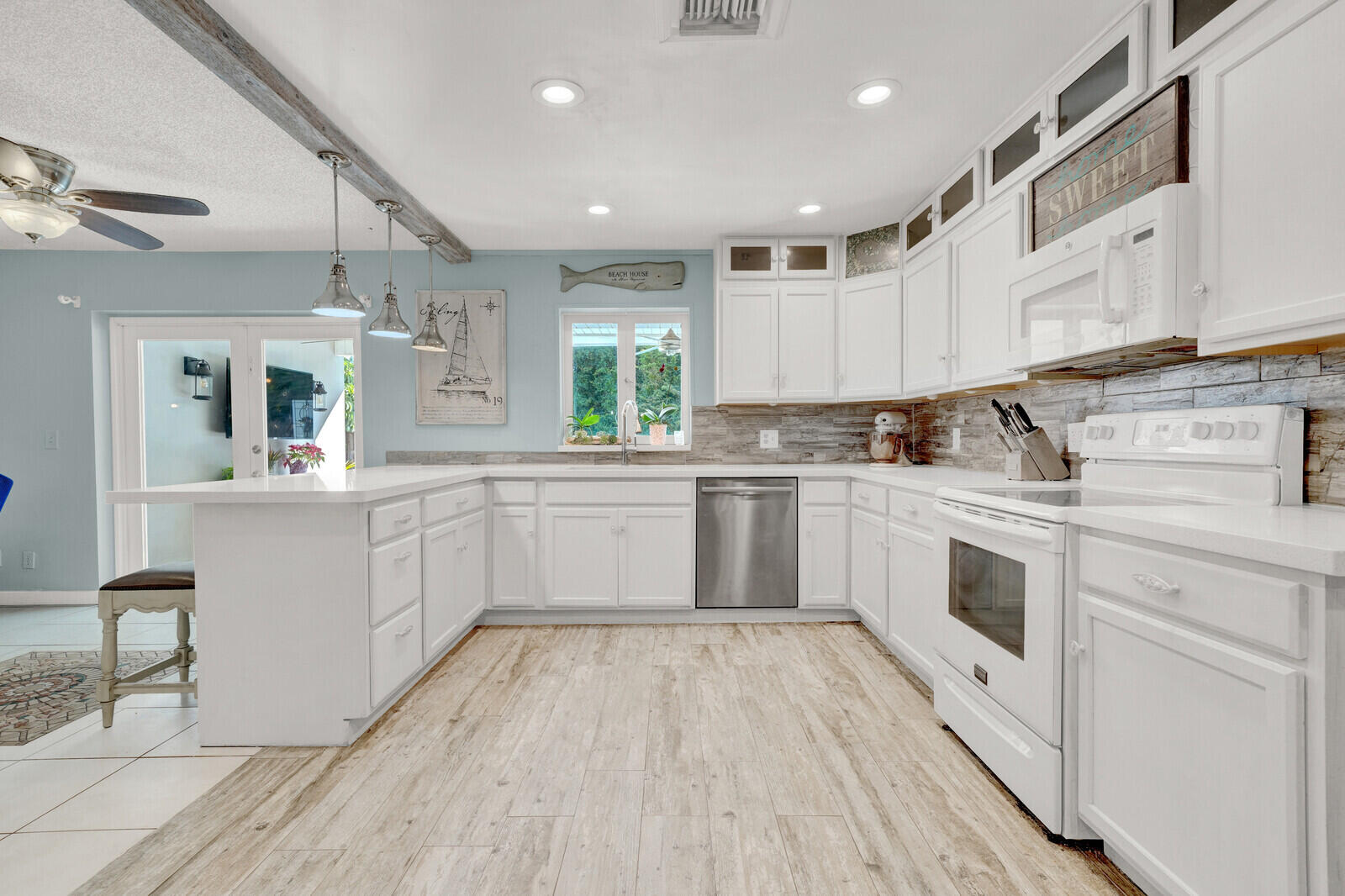 10406 Sleepy Brook Way Boca Raton, FL 33428 - Photo 8 of 36 a kitchen with white cabinets sink and white appliances