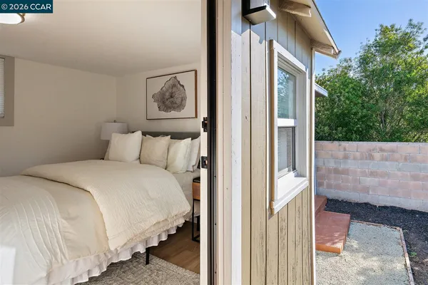a bedroom with a bed and a painting on the wall