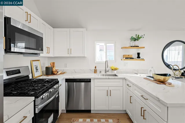 a kitchen with a stove a sink and a microwave