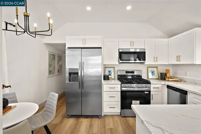 a kitchen with stainless steel appliances a refrigerator stove microwave and cabinets