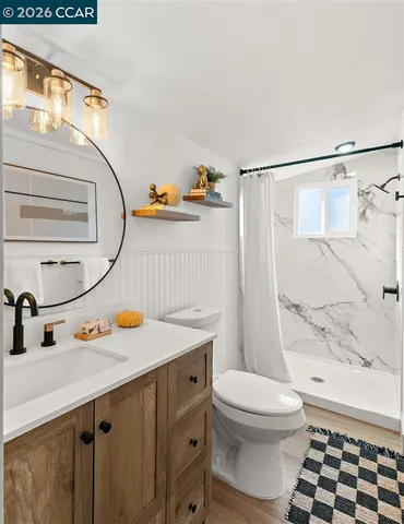 a bathroom with a sink toilet and shower