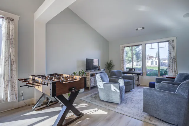 a view of a workspace with furniture and a window
