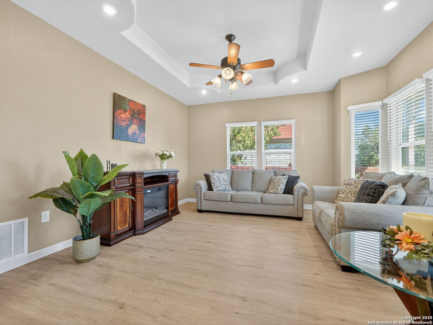 a living room with furniture a chandelier and a fireplace