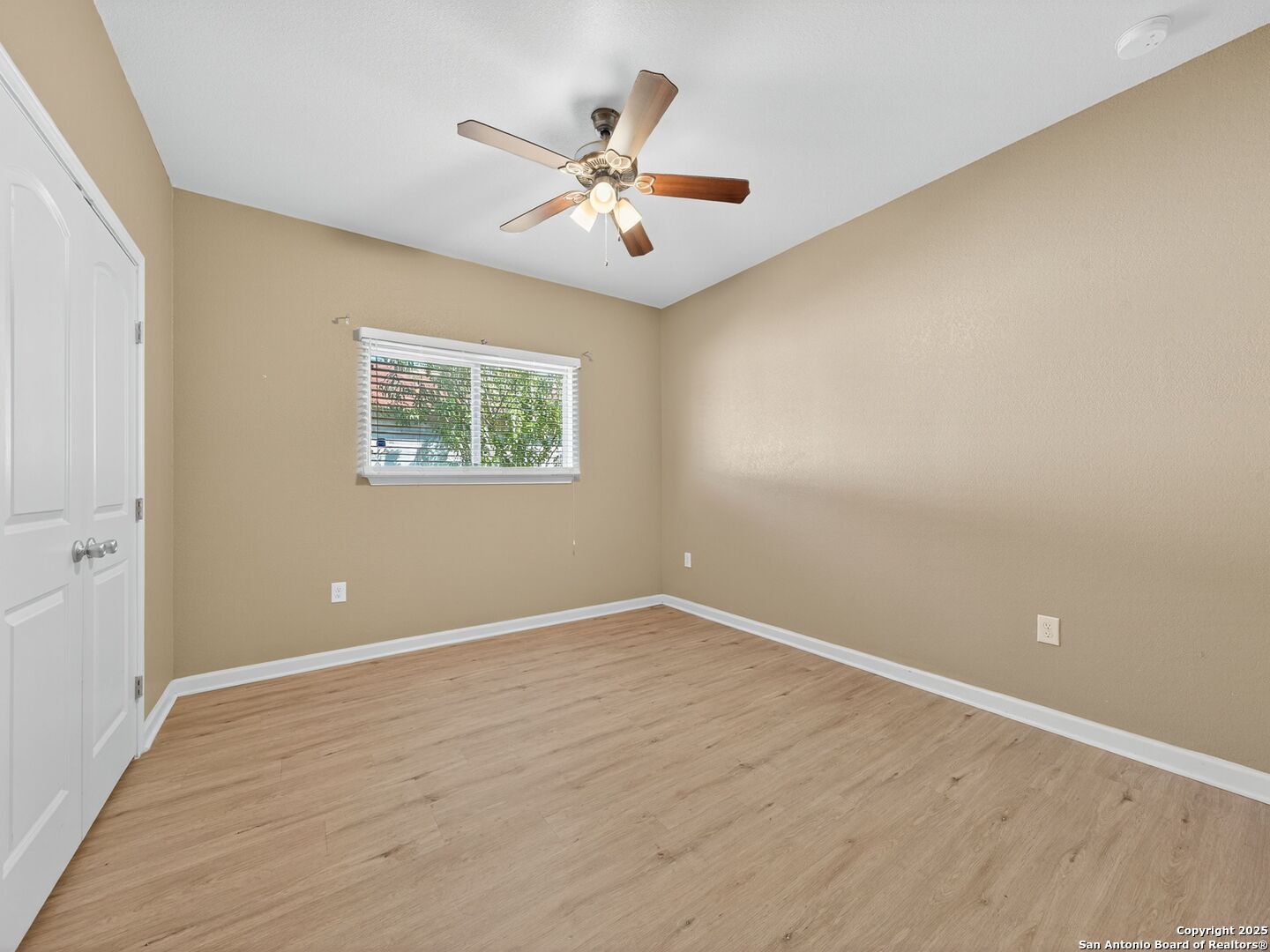 605 Meadow Gate Converse, TX 78109 - Photo 20 of 27 an empty room with wooden floor chandelier fan and windows