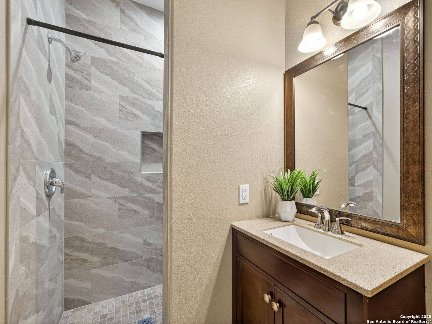 605 Meadow Gate Converse, TX 78109 - Photo 21 of 27 a bathroom with a granite countertop sink and a mirror