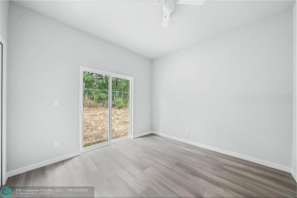 Undisclosed Address Sebring, FL 33870 - Photo 4 of 8 an empty room with wooden floor and windows