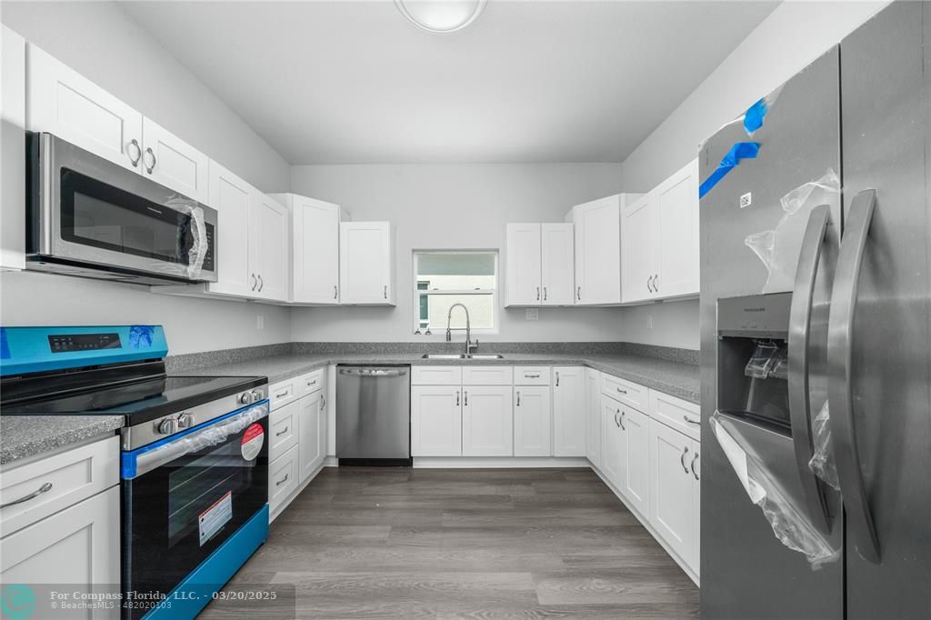 Undisclosed Address Sebring, FL 33870 - Photo 7 of 8 a kitchen with stainless steel appliances granite countertop a sink and a stove top oven