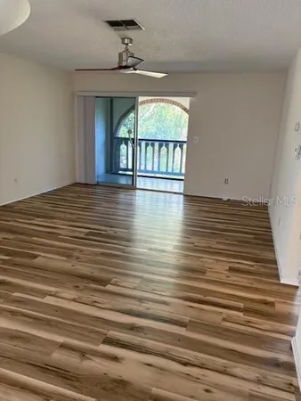 a view of a room with window and wooden floor