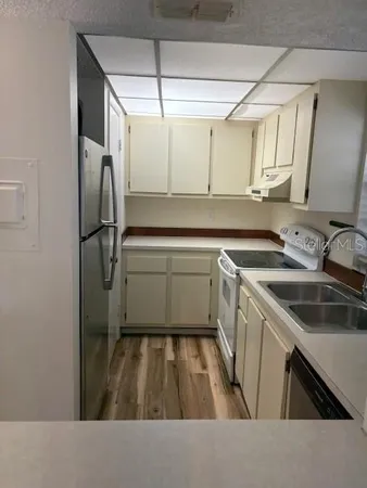 a kitchen with a sink appliances and cabinets