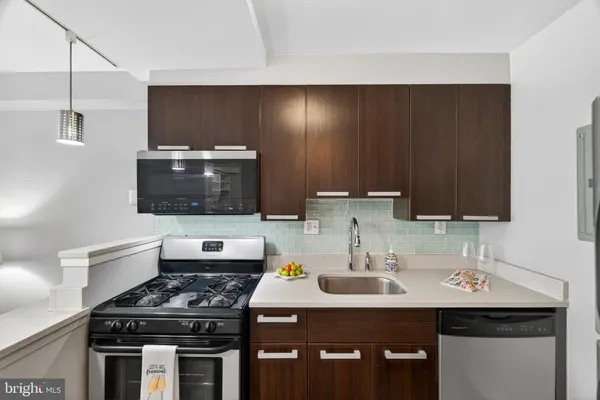 a kitchen with a sink and a stove top oven
