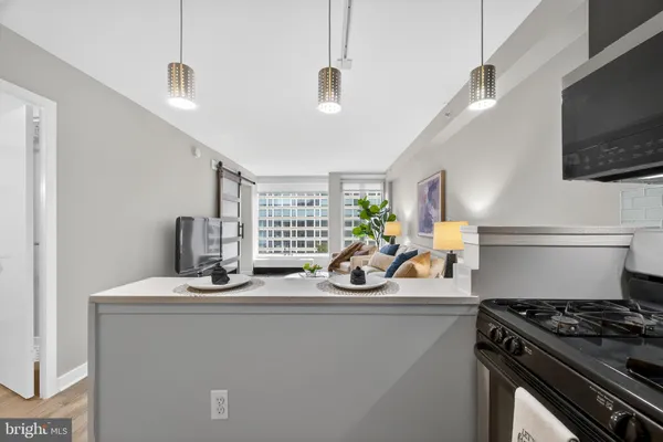 a kitchen with stainless steel appliances a sink stove and microwave