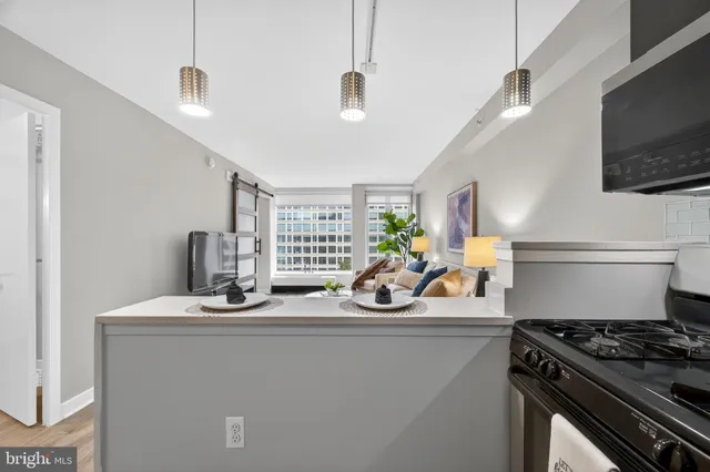 a kitchen with stainless steel appliances a sink stove and microwave