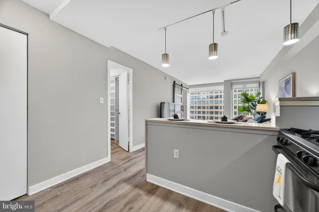 a kitchen with stainless steel appliances a white stove top oven a sink and a refrigerator