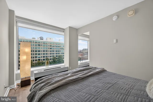a view of a bedroom with wooden floor and a window