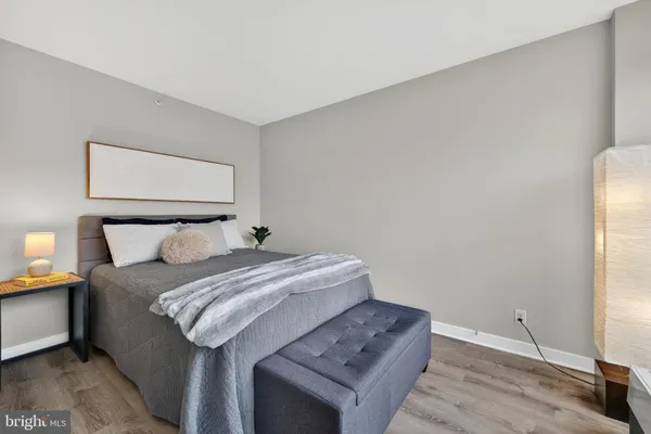 a bedroom with a bed and a night stand