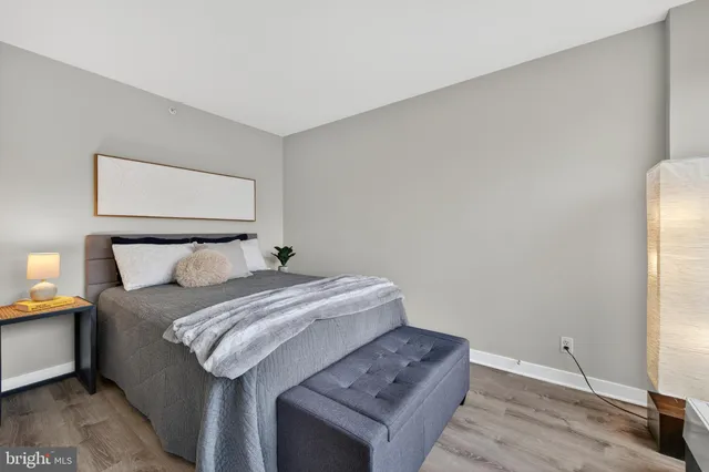 a bedroom with a bed and a night stand